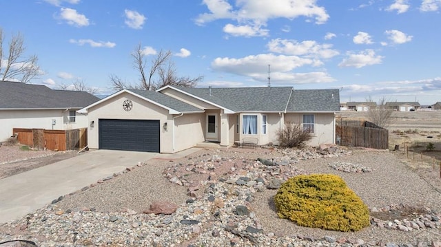 ranch-style house with fence, roof with shingles, stucco siding, concrete driveway, and a garage