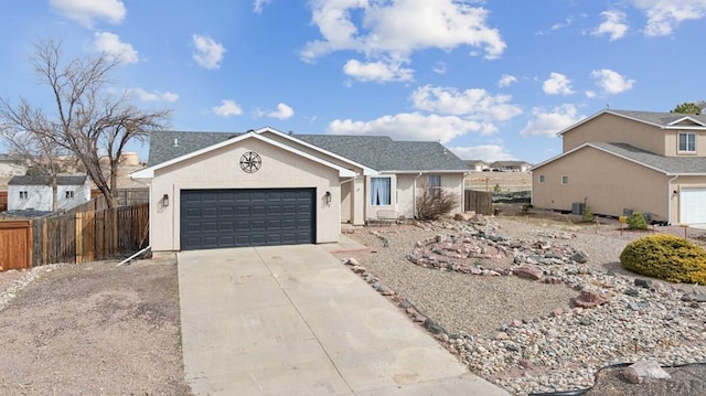 ranch-style home featuring a garage, concrete driveway, stucco siding, and fence