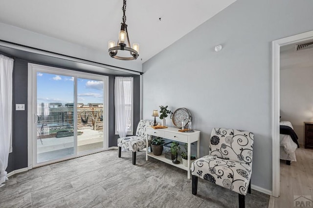 living area with visible vents, an inviting chandelier, baseboards, and vaulted ceiling