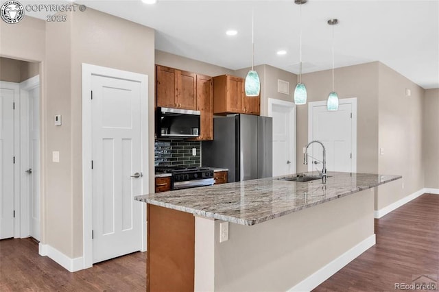 3010 Grandview Ave, Canon City, CO 81212 - kitchen with dark wood-type flooring, stainless steel appliances, brown cabinetry, decorative backsplash, and recessed lighting