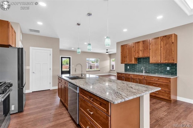 3010 Grandview Ave, Canon City, CO 81212 - kitchen featuring brown cabinetry, wood finished floors, stainless steel appliances, decorative light fixtures, and recessed lighting