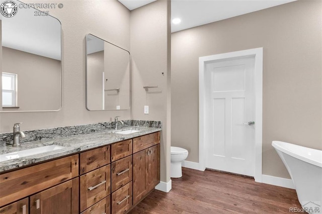3010 Grandview Ave, Canon City, CO 81212 - bathroom with double vanity, a freestanding bath, and wood finished floors