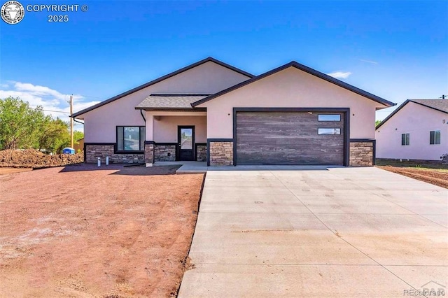 3010 Grandview Ave, Canon City, CO 81212 - view of front of property with stucco siding, stone siding, concrete driveway, and an attached garage