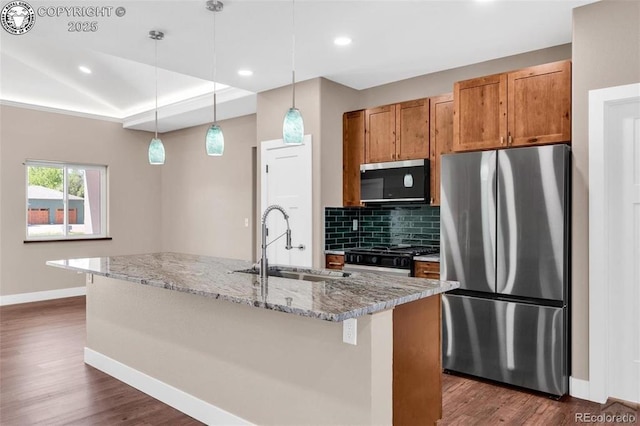 3010 Grandview Ave, Canon City, CO 81212 - kitchen with stainless steel appliances, dark wood-style floors, decorative backsplash, decorative light fixtures, and light stone counters
