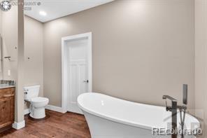 3010 Grandview Ave, Canon City, CO 81212 - bathroom with a freestanding bath, vanity, and wood finished floors