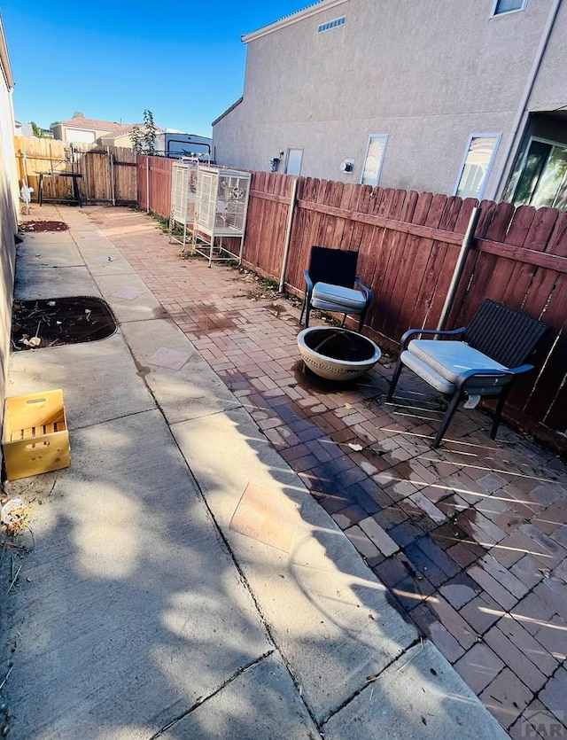 view of patio / terrace with an outdoor fire pit and a fenced backyard