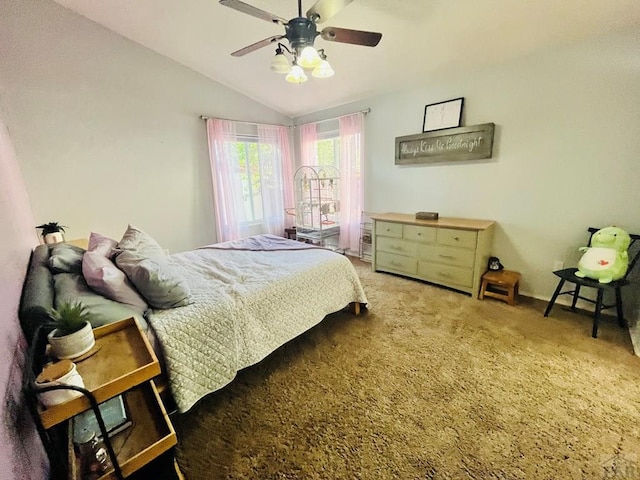 bedroom with vaulted ceiling, carpet floors, and a ceiling fan