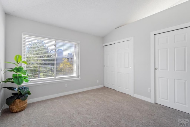 3666 Iguana Dr, Colorado Springs, CO 80910 - unfurnished bedroom with lofted ceiling, carpet flooring, baseboards, and a closet