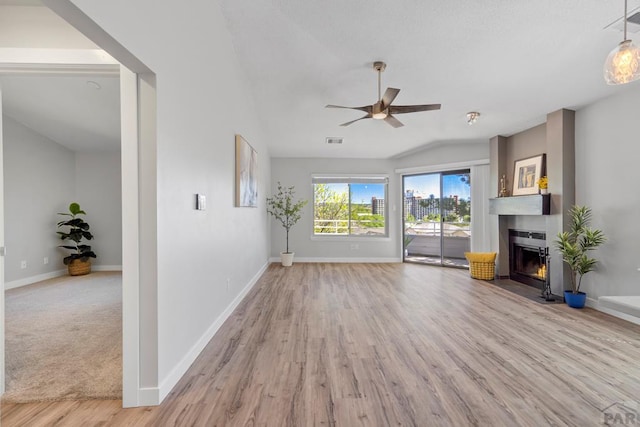 3666 Iguana Dr, Colorado Springs, CO 80910 - unfurnished living room featuring baseboards, a fireplace with flush hearth, light wood-style floors, and a ceiling fan