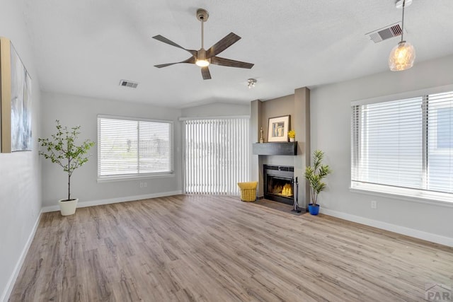 3666 Iguana Dr, Colorado Springs, CO 80910 - unfurnished living room featuring wood finished floors, a ceiling fan, a large fireplace, and baseboards