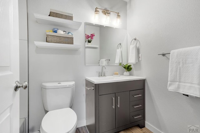 3666 Iguana Dr, Colorado Springs, CO 80910 - bathroom featuring vanity, toilet, and wood finished floors
