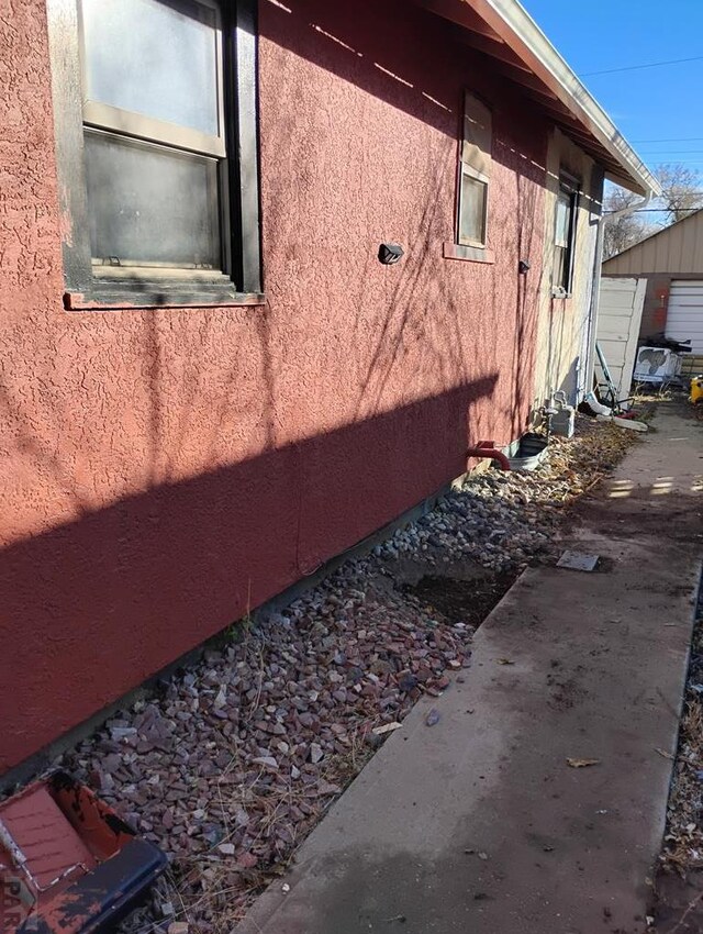 view of side of home featuring stucco siding