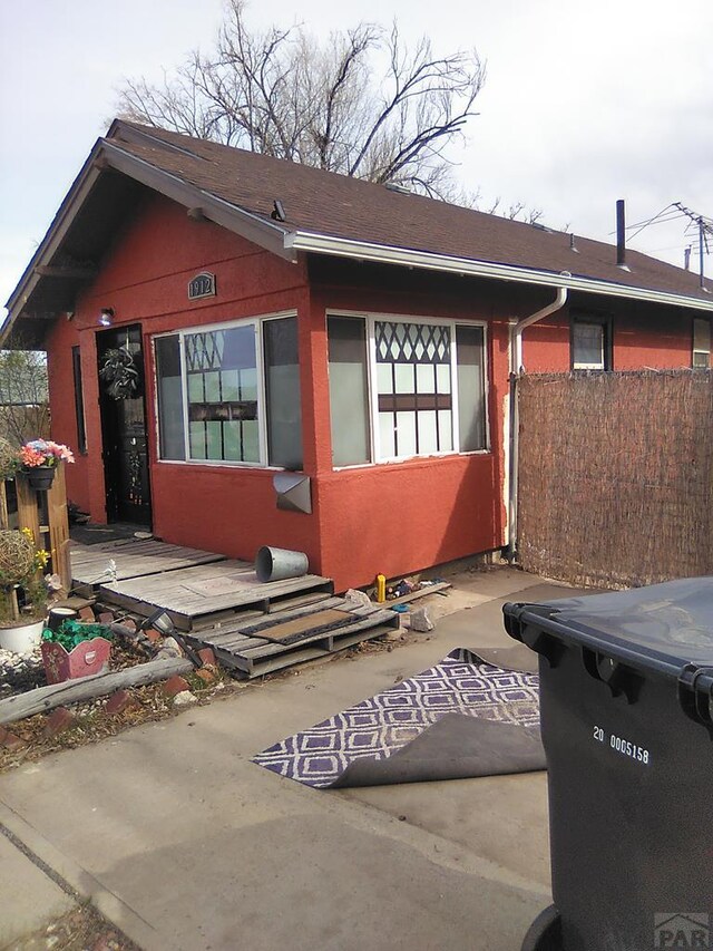 view of side of property featuring fence and a patio