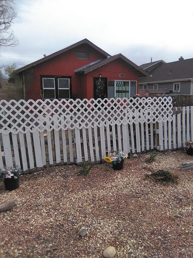 view of front of home featuring fence