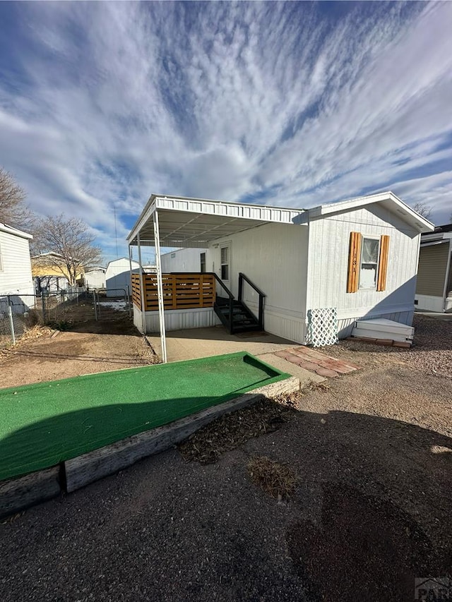 view of home's exterior featuring a deck and fence