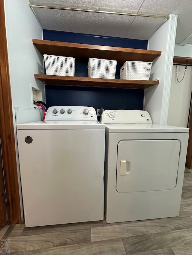 laundry area with washer and dryer, light wood-type flooring, and laundry area