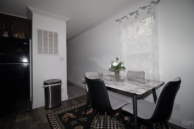 218 W Thurlow Ave, Cripple Creek, CO 80813 - dining space with crown molding, dark wood-style flooring, and baseboards