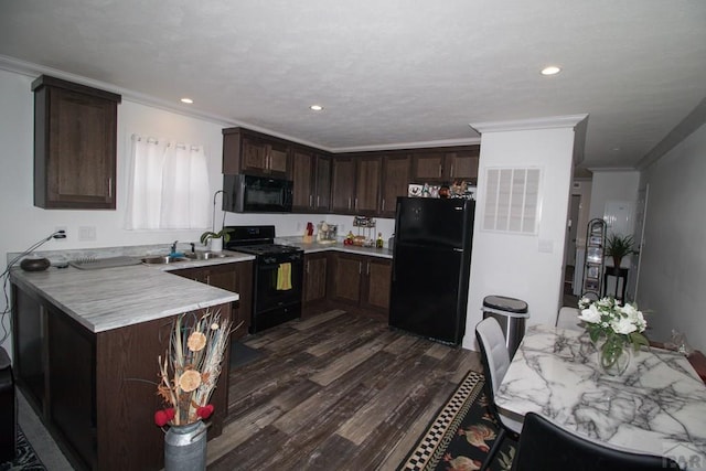 218 W Thurlow Ave, Cripple Creek, CO 80813 - kitchen with black appliances, dark brown cabinets, dark wood-style floors, light countertops, and a peninsula