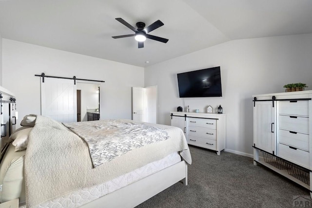 bedroom with a barn door, a ceiling fan, vaulted ceiling, dark colored carpet, and baseboards