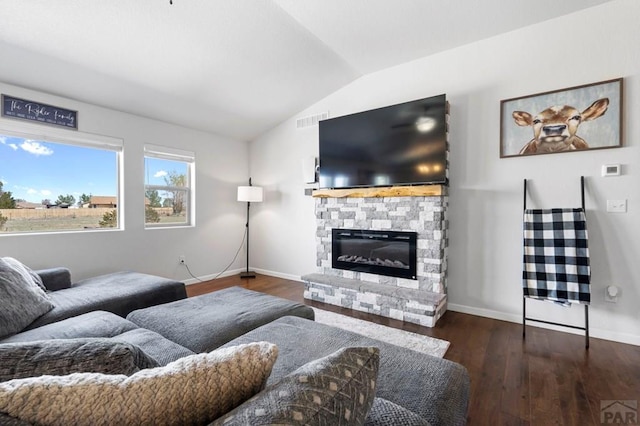 living room with visible vents, baseboards, vaulted ceiling, a fireplace, and wood finished floors