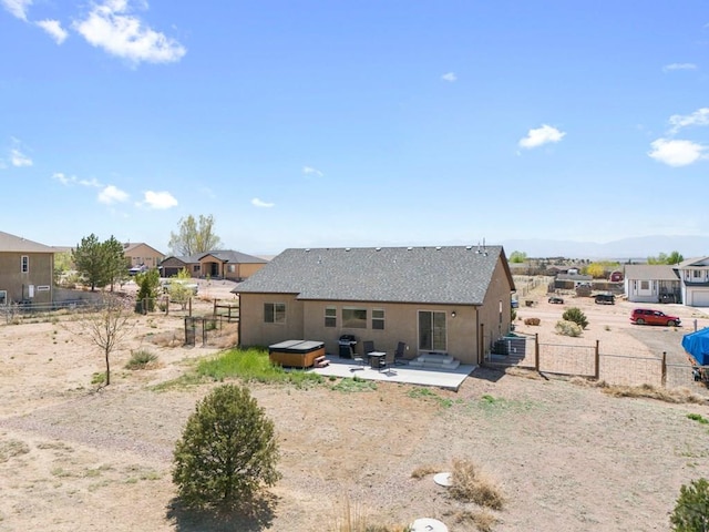 back of house with a residential view, a patio, a jacuzzi, and a fenced backyard
