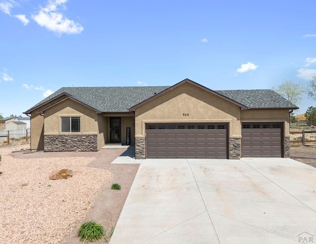 ranch-style house featuring a garage, stone siding, concrete driveway, stucco siding, and fence