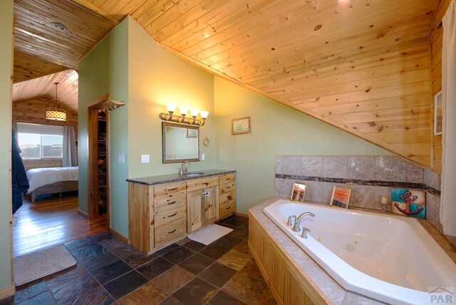 1160 Diamond Black Trl, Canon City, CO 81212 - ensuite bathroom with wood ceiling, vanity, a jetted tub, ensuite bath, and vaulted ceiling