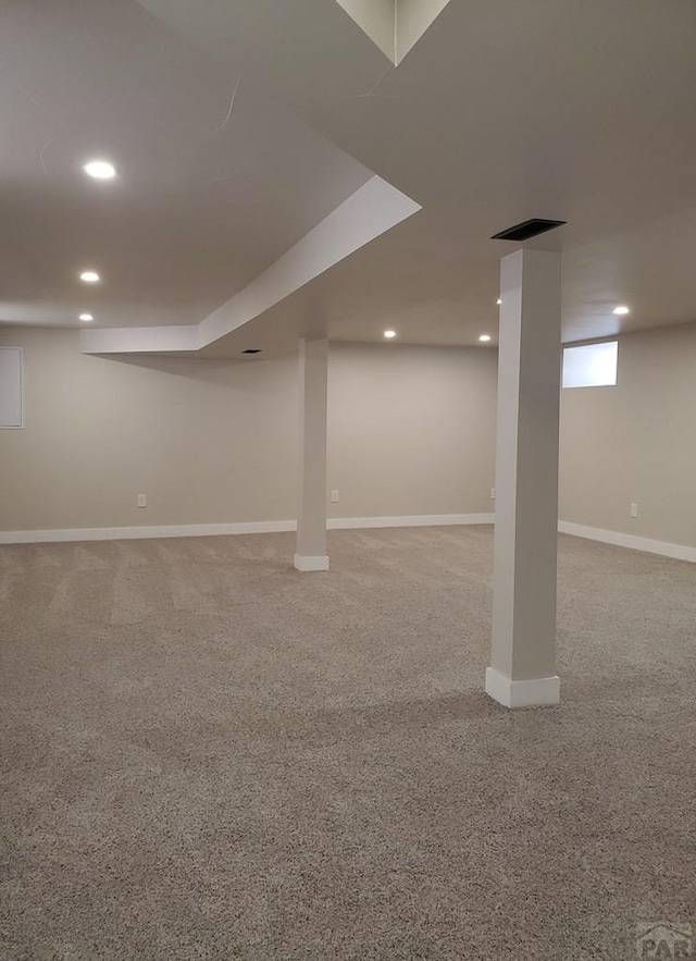 below grade area with recessed lighting, carpet flooring, visible vents, and baseboards