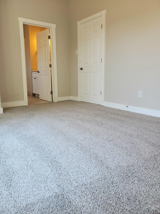 unfurnished bedroom featuring carpet floors and baseboards