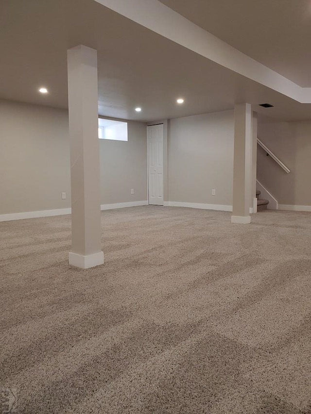 below grade area featuring visible vents, stairs, baseboards, and recessed lighting