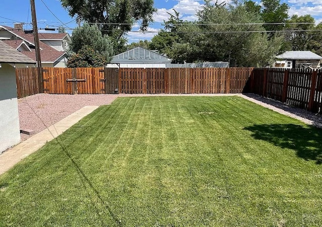 view of yard featuring a gate and a fenced backyard