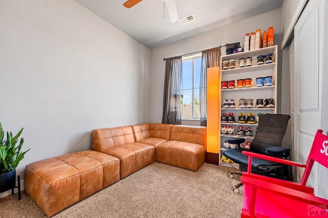 sitting room with carpet floors, lofted ceiling, and a ceiling fan