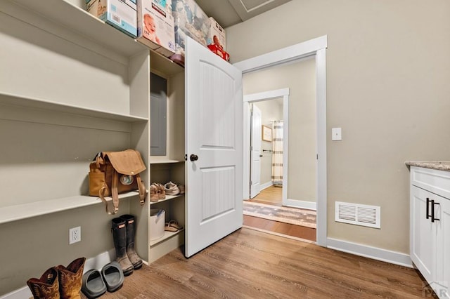 washroom with wood finished floors and baseboards