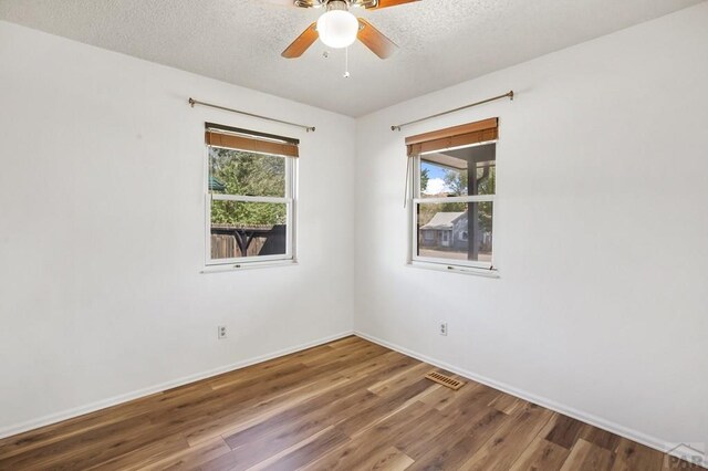 118 W Stanley Ave, Canon City, CO 81212 - unfurnished room featuring wood finished floors, baseboards, a textured ceiling, and a ceiling fan