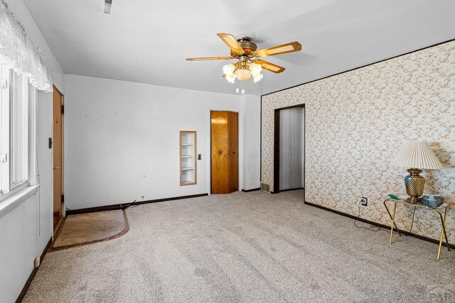 1404 Martin Ln, Avondale, CO 81025 - unfurnished bedroom with baseboards, ceiling fan, carpet, and wallpapered walls