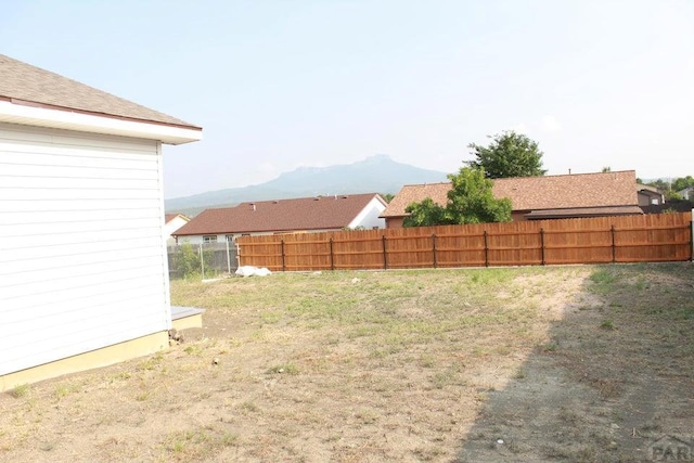 view of yard with a mountain view and fence