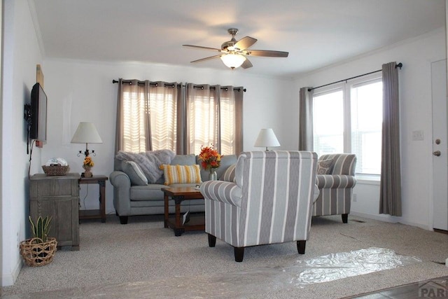 living area with light carpet, ceiling fan, and crown molding