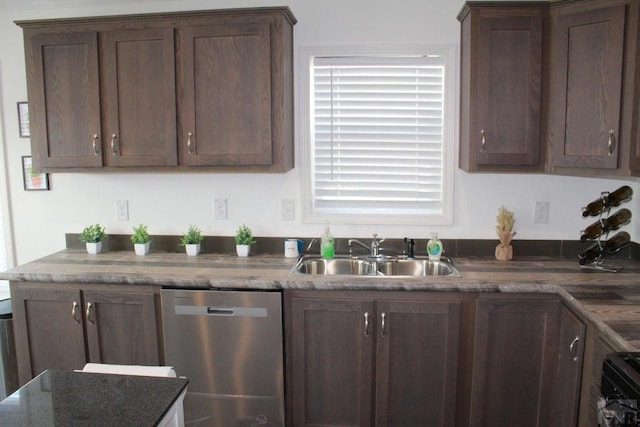 kitchen with a sink, dark stone counters, dark brown cabinets, and stainless steel dishwasher