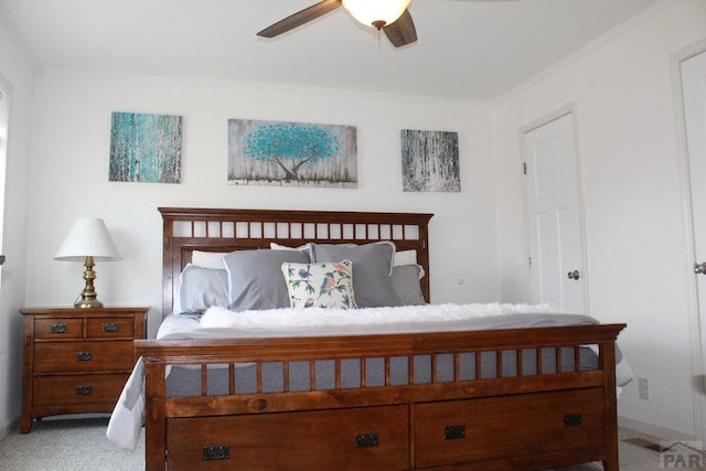 carpeted bedroom featuring ornamental molding and ceiling fan