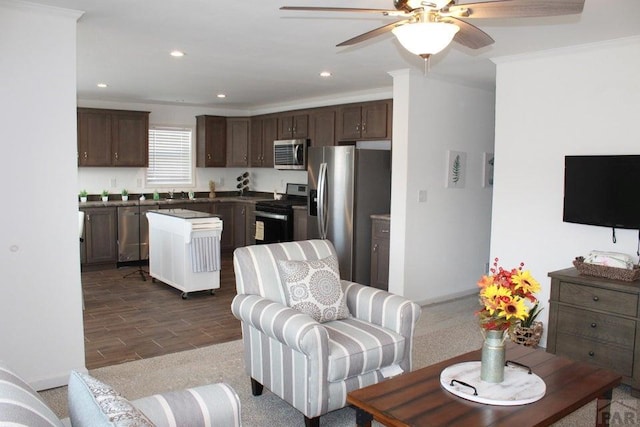 interior space featuring crown molding, recessed lighting, appliances with stainless steel finishes, a ceiling fan, and dark brown cabinets