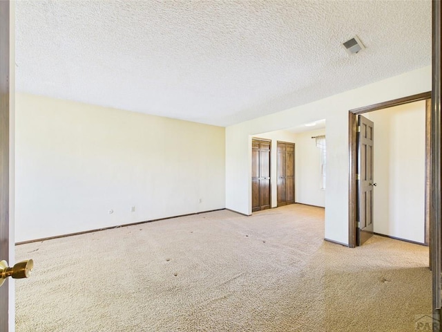 9 Woodsorrel Ct, Pueblo, CO 81001 - carpeted empty room with baseboards and a textured ceiling