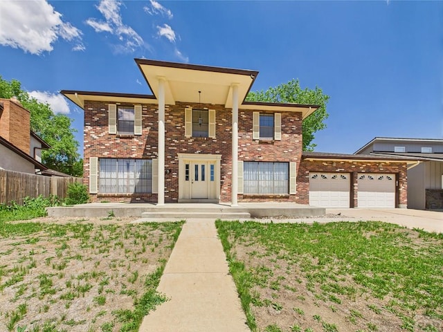 9 Woodsorrel Ct, Pueblo, CO 81001 - neoclassical / greek revival house featuring fence, an attached garage, brick siding, and concrete driveway