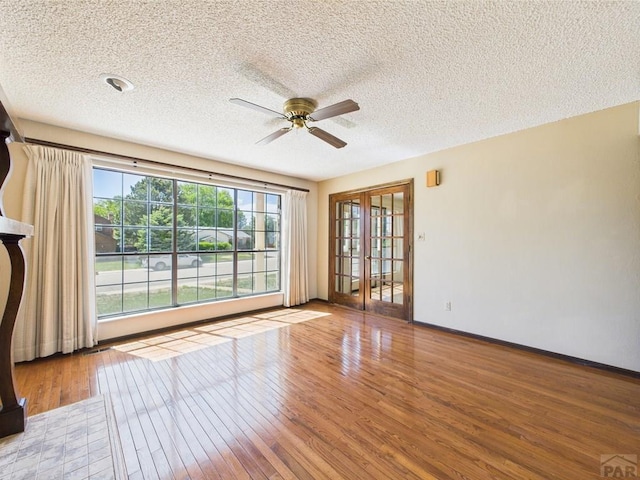 9 Woodsorrel Ct, Pueblo, CO 81001 - empty room with a textured ceiling, ceiling fan, wood finished floors, and baseboards