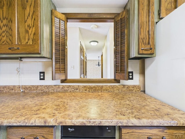9 Woodsorrel Ct, Pueblo, CO 81001 - kitchen with decorative backsplash, light countertops, and brown cabinets