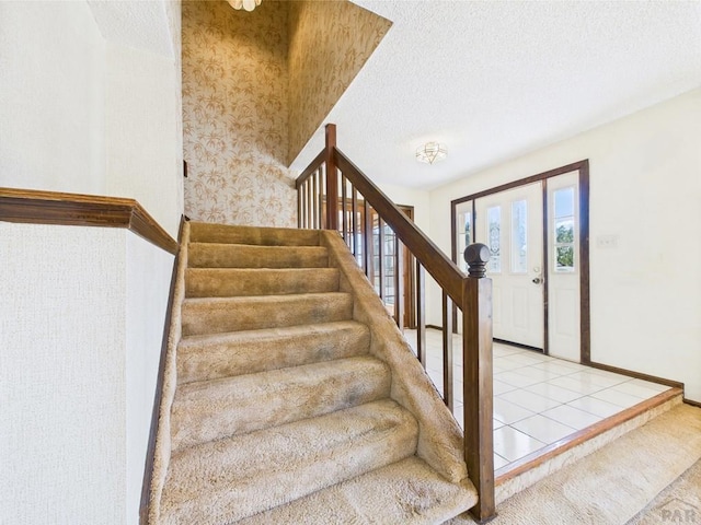 9 Woodsorrel Ct, Pueblo, CO 81001 - stairway featuring a textured ceiling and baseboards