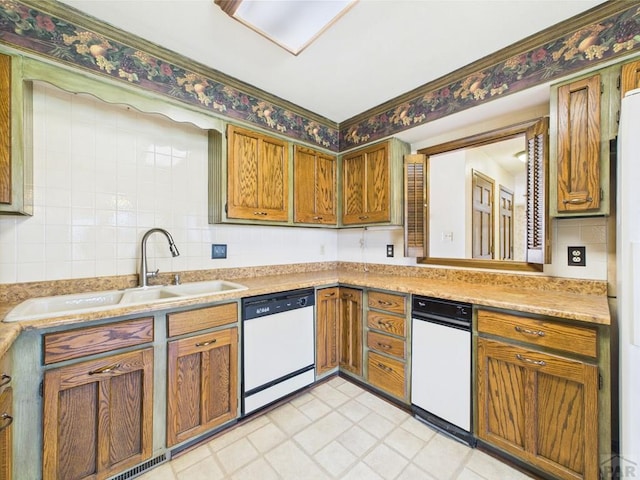 9 Woodsorrel Ct, Pueblo, CO 81001 - kitchen with white dishwasher, a sink, light countertops, brown cabinets, and light floors