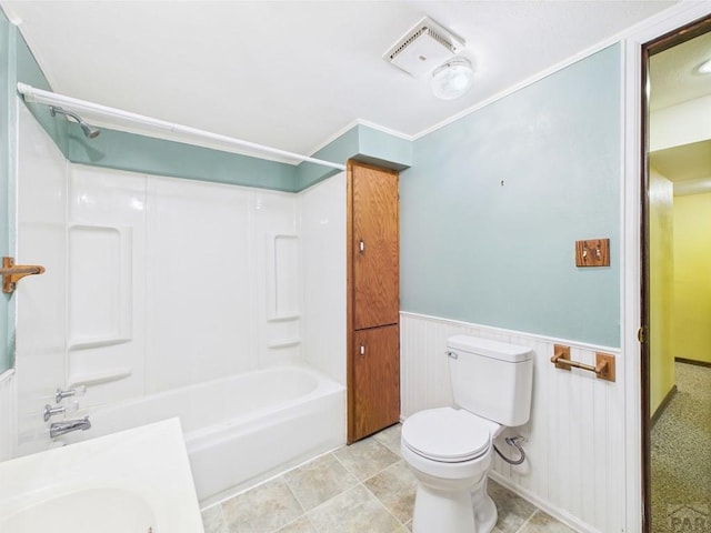 9 Woodsorrel Ct, Pueblo, CO 81001 - bathroom with toilet, wainscoting, and shower / washtub combination