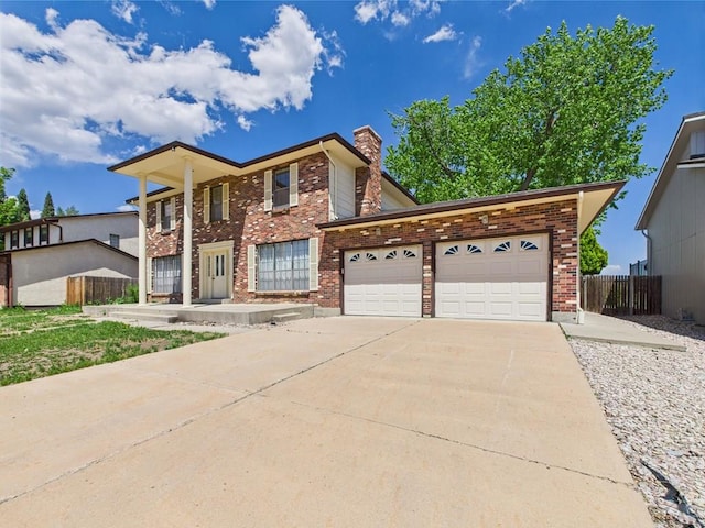 9 Woodsorrel Ct, Pueblo, CO 81001 - greek revival inspired property featuring an attached garage, a chimney, concrete driveway, brick siding, and fence