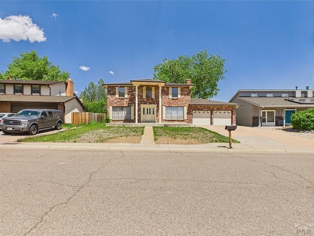 9 Woodsorrel Ct, Pueblo, CO 81001 - townhome / multi-family property featuring concrete driveway, an attached garage, brick siding, and fence