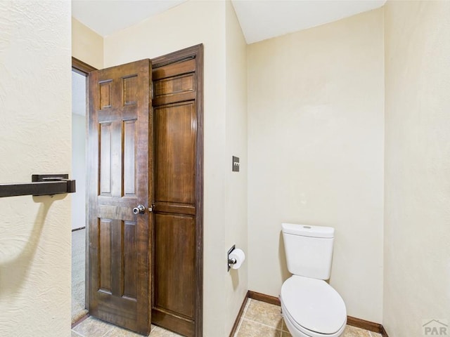 9 Woodsorrel Ct, Pueblo, CO 81001 - bathroom featuring toilet, baseboards, and tile patterned floors